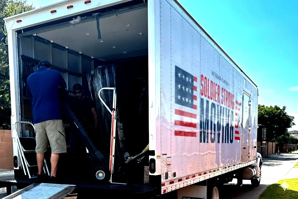 image of a movers loading the truck with packed items