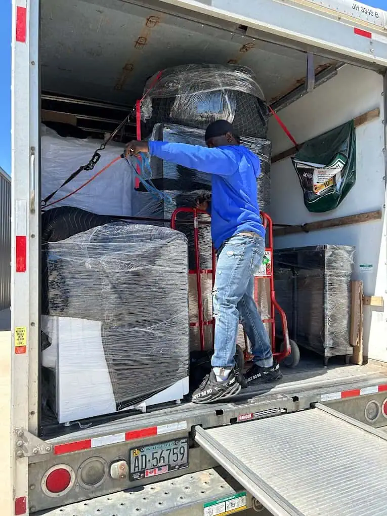 image of movers loading the truck with packed household supplies